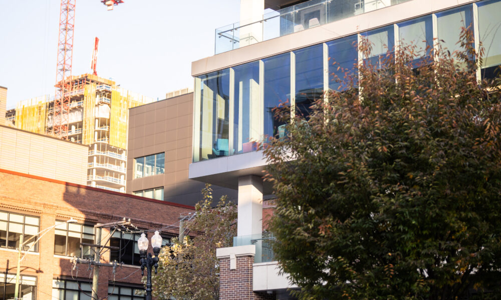 SpaceCo, glass walls, pillars, across the street, red crane in background, google headquarters