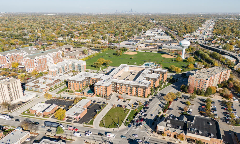 SpaceCo, aerial shot of apartments, wider shot, street, field, skyline, uptown lagrange