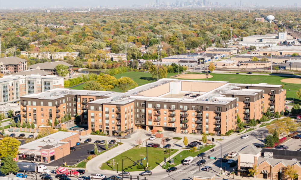 SpaceCo, aerial shot of apartment building, skyline in background, street on bottom, uptown lagrange