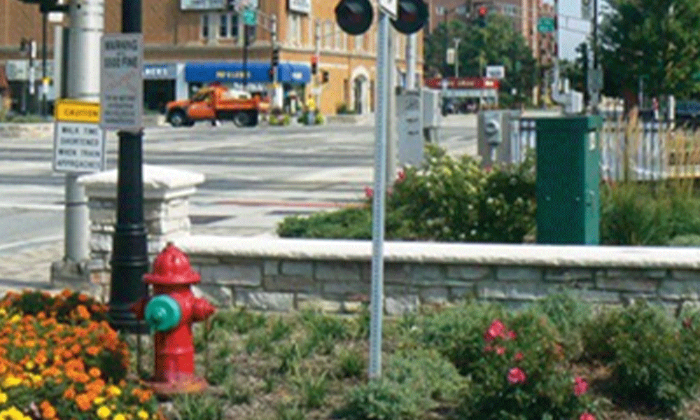 SpaceCo, flower bed in front of wall, street signs, orange truck and buildings in background, city of des plaines streetscape improvements, des plaines streetscape picture #1 resized